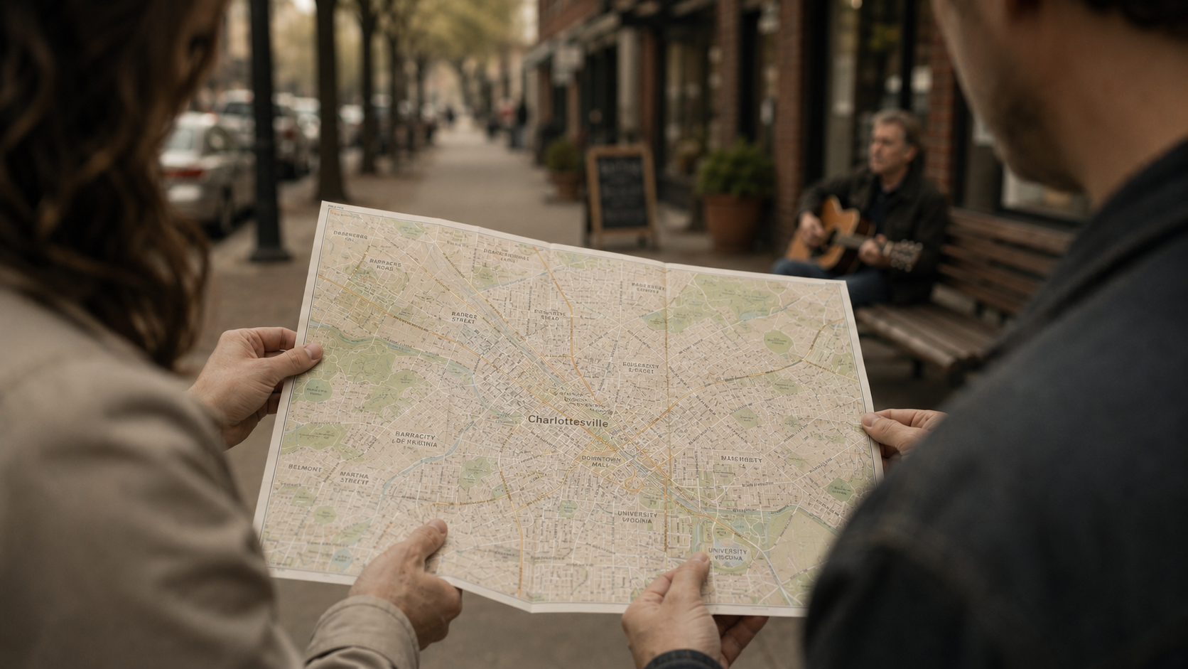 Two people navigating Charlottesville together, holding a local map